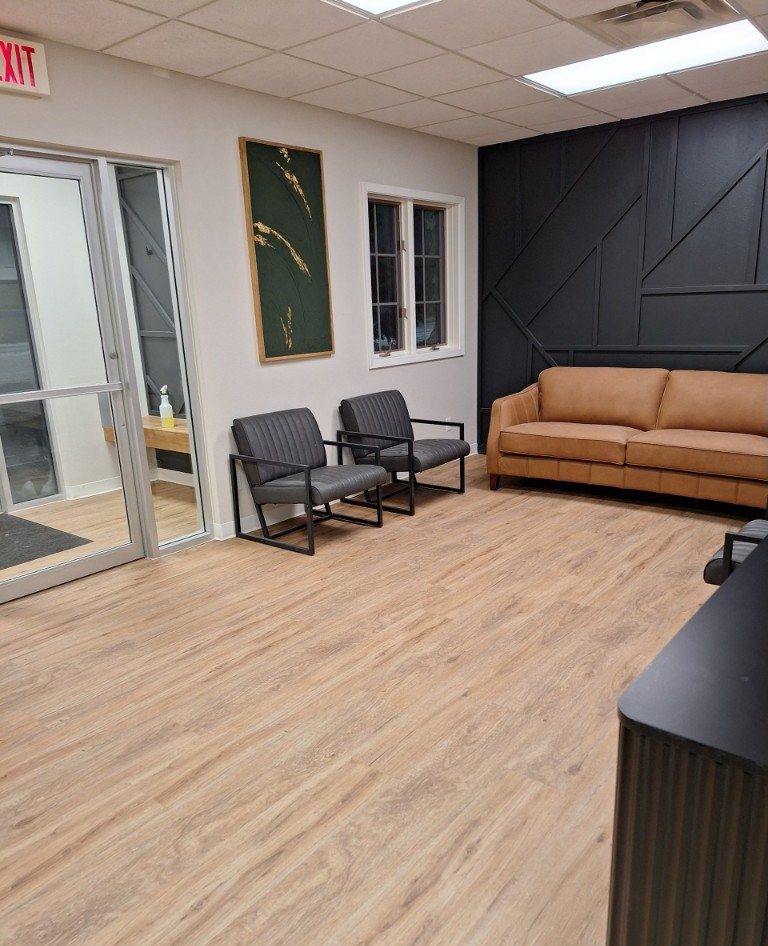 Light oak LVP in a commercial waiting room, installed by Barefoot Flooring