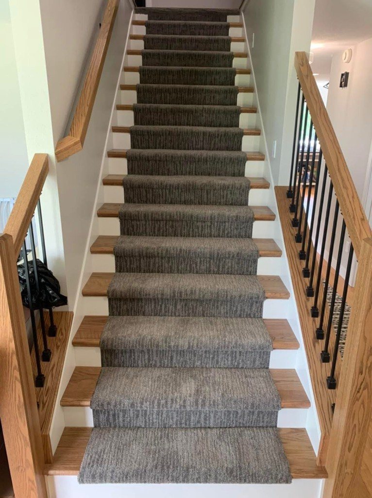 Charcoal carpet runner on oak stairs with white risers