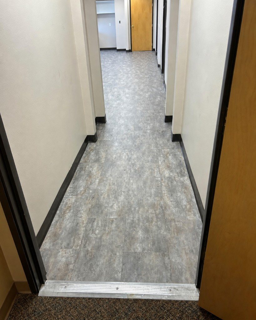 Stone look LVT in a commercial hallway
